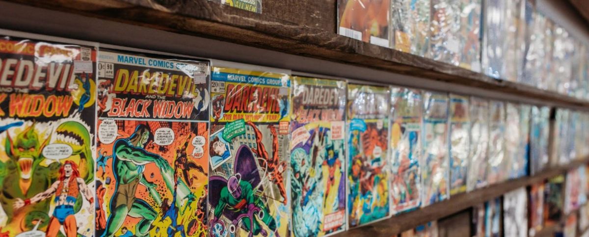 Vintage Daredevil comics displayed on wooden shelves